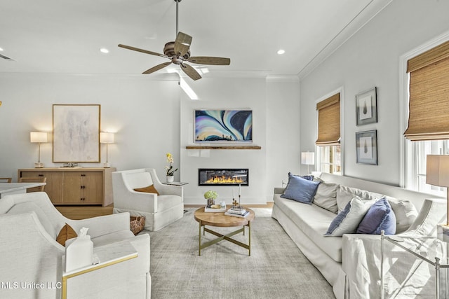 living room with visible vents, crown molding, ceiling fan, recessed lighting, and a glass covered fireplace