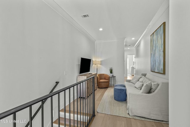 living room featuring recessed lighting, ornamental molding, visible vents, and wood finished floors