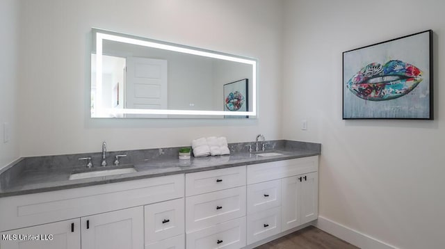 132 Markham Dr, Gulfport, MS 39507 - bathroom featuring double vanity, baseboards, and wood finished floors