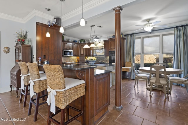 kitchen with ceiling fan, a kitchen breakfast bar, backsplash, crown molding, and oven