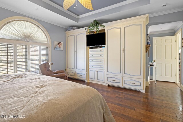 bedroom with a raised ceiling, ceiling fan, dark hardwood / wood-style flooring, and ornamental molding