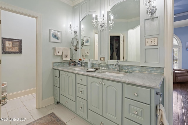 bathroom with tile patterned flooring, vanity, and ornamental molding