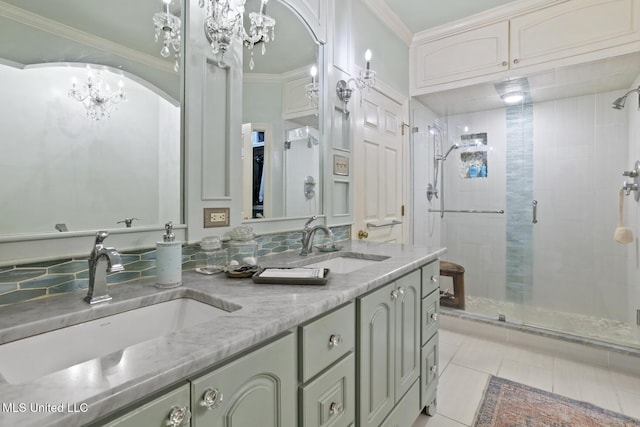 bathroom featuring an inviting chandelier, tile patterned flooring, crown molding, vanity, and a shower with shower door