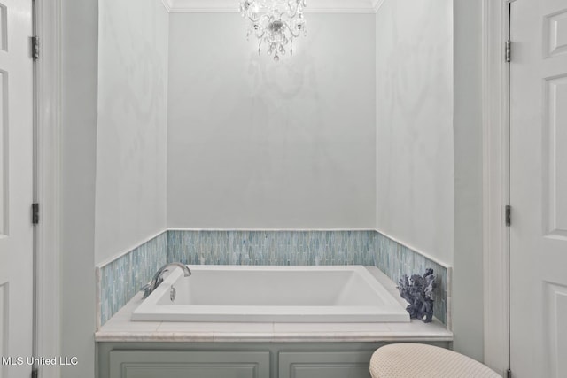 bathroom with a bathing tub, crown molding, and a notable chandelier