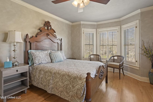 bedroom with ceiling fan, light wood-type flooring, and crown molding