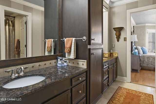 bathroom with tile patterned flooring, vanity, decorative backsplash, and ornamental molding