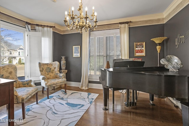 sitting room with a chandelier, hardwood / wood-style flooring, and ornamental molding