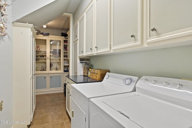 washroom featuring cabinets and separate washer and dryer