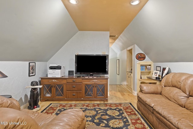 living room with light wood-type flooring and vaulted ceiling