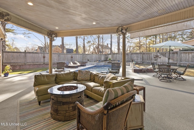 view of patio featuring an outdoor fire pit and a covered pool