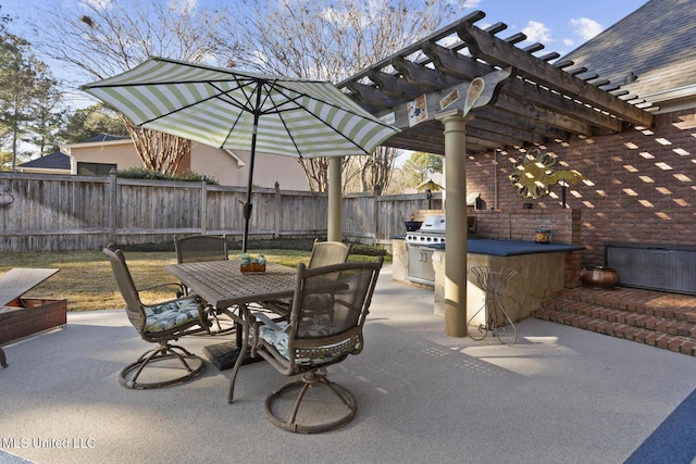 view of patio featuring exterior kitchen and a pergola