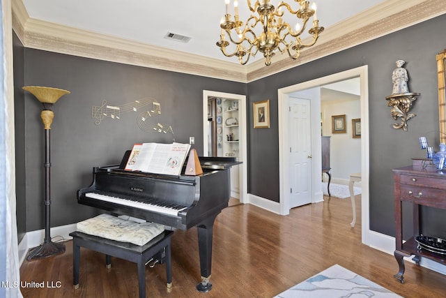 miscellaneous room featuring hardwood / wood-style floors, ornamental molding, and a notable chandelier