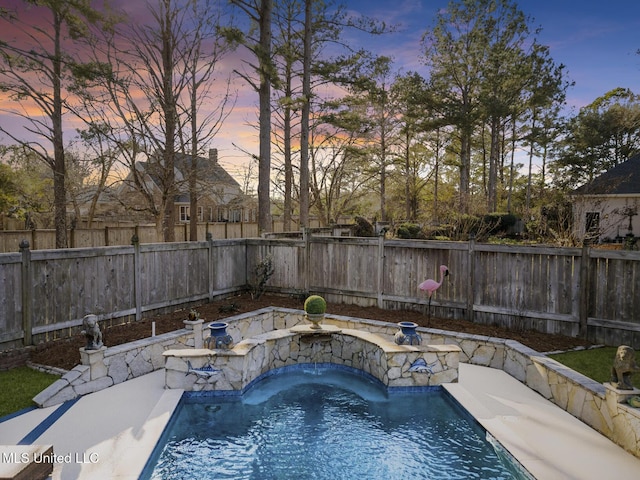 pool at dusk featuring pool water feature