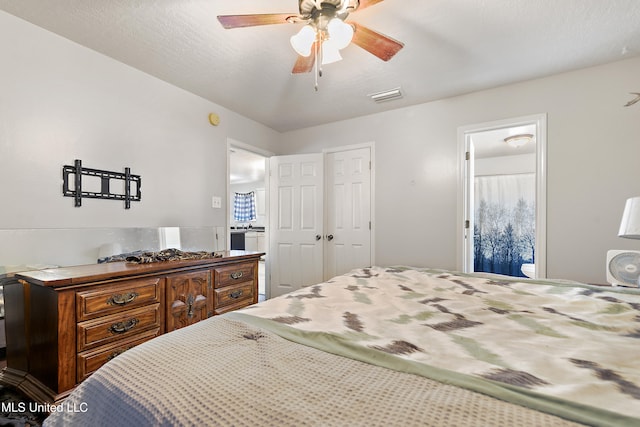 bedroom featuring a textured ceiling, connected bathroom, a closet, and ceiling fan