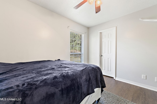 bedroom featuring a textured ceiling, dark hardwood / wood-style flooring, and ceiling fan