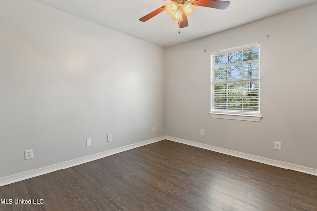 spare room with dark hardwood / wood-style flooring and ceiling fan