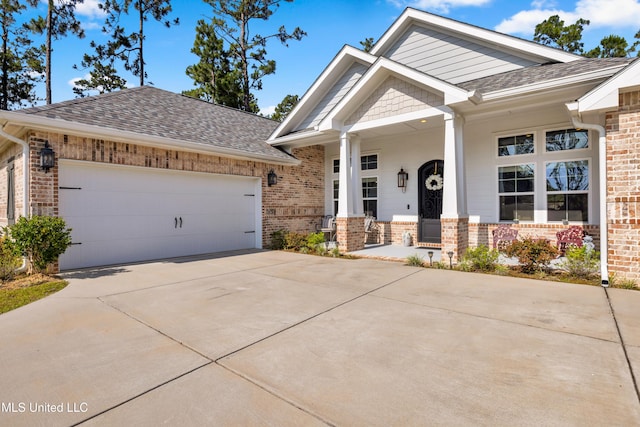 12578 Alphabet Rd, Gulfport, MS 39503 - craftsman-style house featuring brick siding, a shingled roof, driveway, and an attached garage