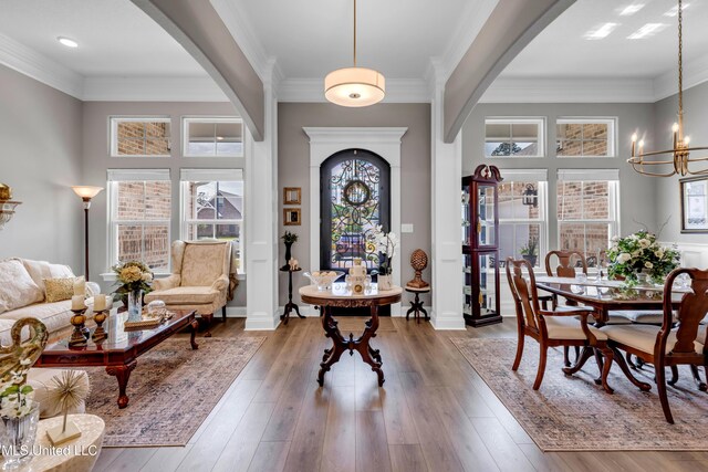 12578 Alphabet Rd, Gulfport, MS 39503 - entryway with arched walkways, a chandelier, ornamental molding, wood finished floors, and baseboards