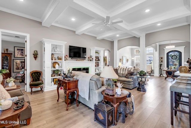 12578 Alphabet Rd, Gulfport, MS 39503 - living room featuring arched walkways, beamed ceiling, a ceiling fan, light wood-style flooring, and ornamental molding