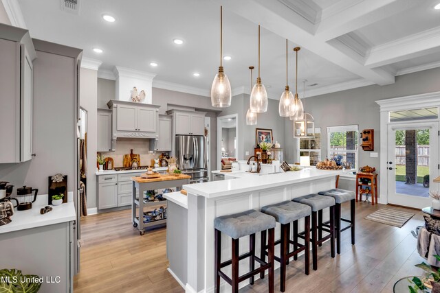 12578 Alphabet Rd, Gulfport, MS 39503 - kitchen with stainless steel fridge with ice dispenser, gray cabinetry, a large island, light countertops, and light wood finished floors