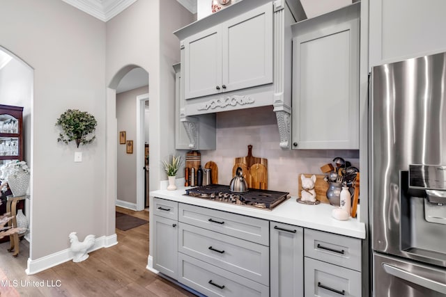12578 Alphabet Rd, Gulfport, MS 39503 - kitchen with stainless steel appliances, arched walkways, ornamental molding, light countertops, and tasteful backsplash