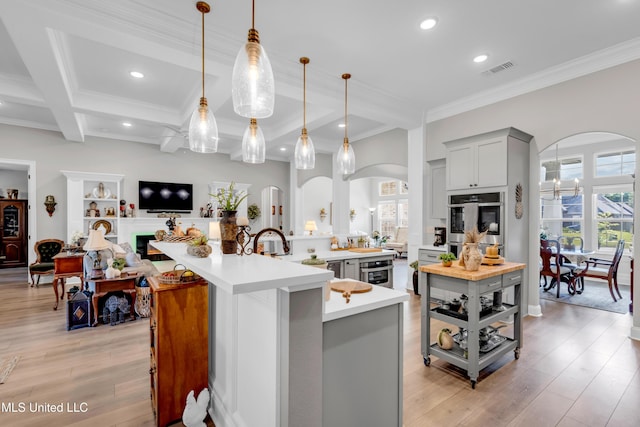 12578 Alphabet Rd, Gulfport, MS 39503 - kitchen with arched walkways, gray cabinetry, light countertops, beamed ceiling, and recessed lighting