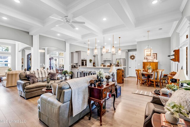 12578 Alphabet Rd, Gulfport, MS 39503 - living area with arched walkways, beamed ceiling, ceiling fan, coffered ceiling, and light wood-style floors