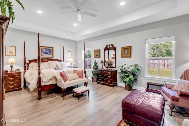 12578 Alphabet Rd, Gulfport, MS 39503 - bedroom with a tray ceiling, light wood-style flooring, recessed lighting, multiple windows, and baseboards