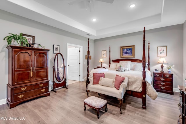 12578 Alphabet Rd, Gulfport, MS 39503 - bedroom featuring light wood-style flooring, baseboards, a raised ceiling, recessed lighting, and ceiling fan