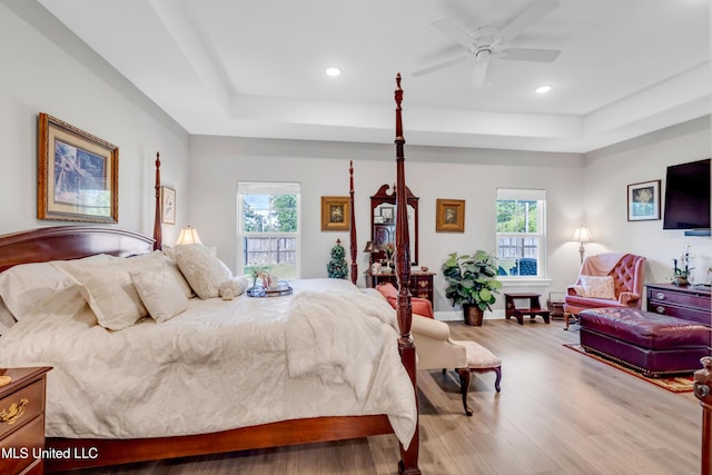 12578 Alphabet Rd, Gulfport, MS 39503 - bedroom featuring a raised ceiling, multiple windows, wood finished floors, and recessed lighting