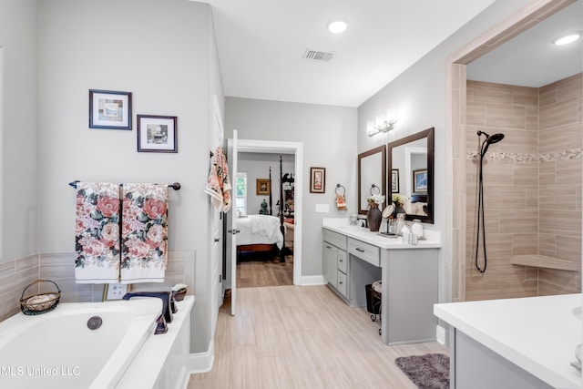 12578 Alphabet Rd, Gulfport, MS 39503 - ensuite bathroom with vanity, a bath, a tile shower, recessed lighting, and baseboards
