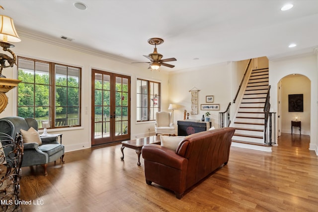 4666 Eiffel Ln, Nesbit, MS 38651 - living area with wood finished floors, a ceiling fan, stairway, ornamental molding, and arched walkways