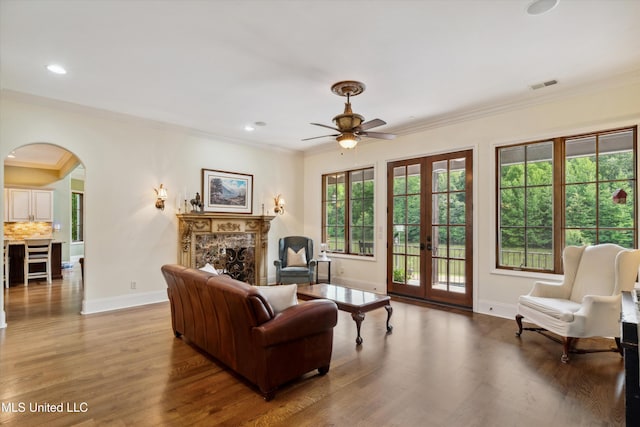4666 Eiffel Ln, Nesbit, MS 38651 - living room featuring arched walkways, a ceiling fan, ornamental molding, wood finished floors, and french doors