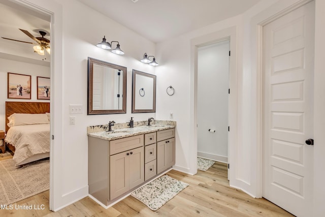 bathroom with ceiling fan, vanity, and hardwood / wood-style flooring