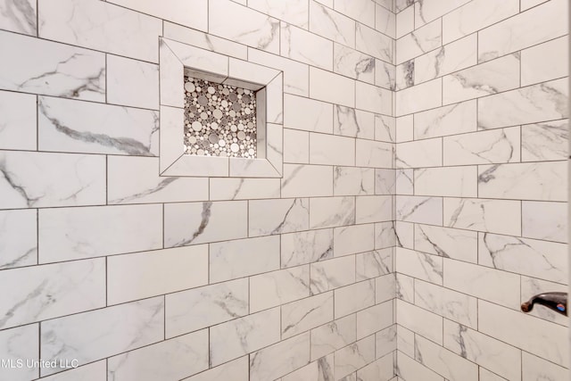 bathroom with tiled shower