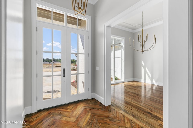 doorway to outside with ornamental molding, french doors, dark parquet floors, and a chandelier