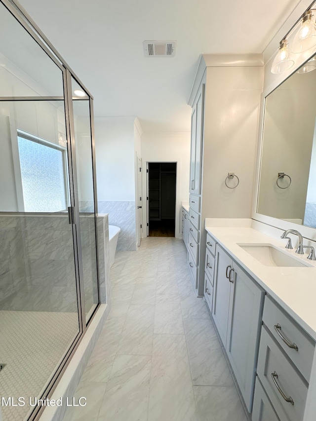 full bathroom featuring marble finish floor, visible vents, two vanities, and a sink