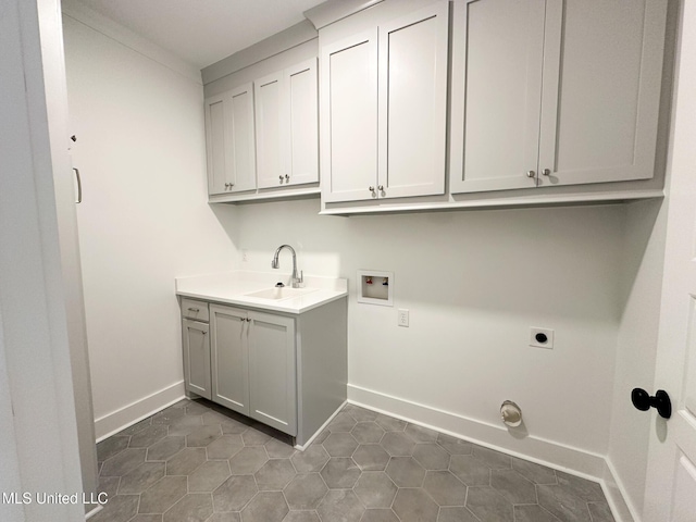 clothes washing area featuring cabinet space, baseboards, hookup for an electric dryer, washer hookup, and a sink