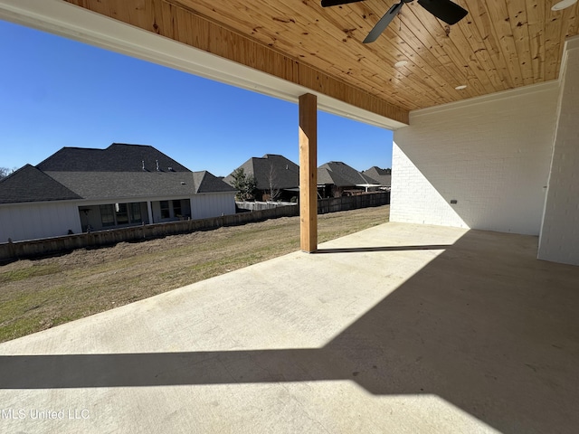 view of patio featuring fence and a ceiling fan