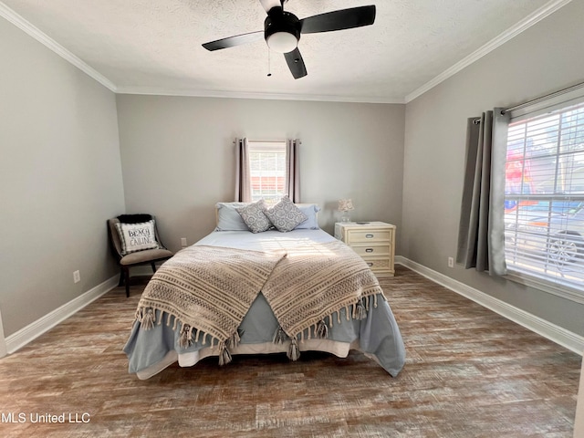 bedroom with a textured ceiling, ceiling fan, wood-type flooring, and ornamental molding