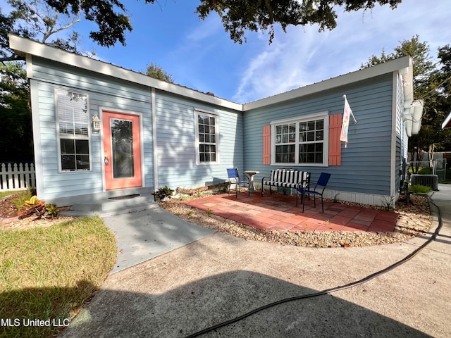 view of front of property featuring central AC and a patio