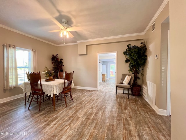 dining room with hardwood / wood-style floors, ceiling fan, and crown molding