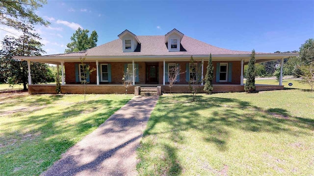 farmhouse-style home with a front lawn and covered porch