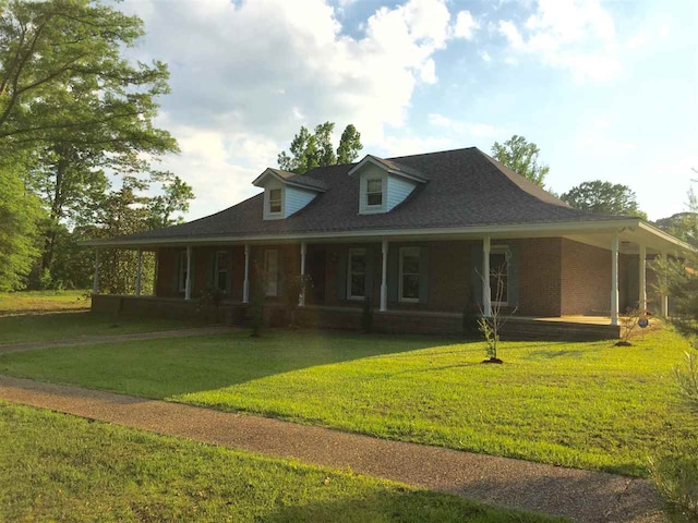 farmhouse-style home with a front yard and covered porch