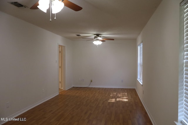 empty room with dark wood-type flooring and ceiling fan