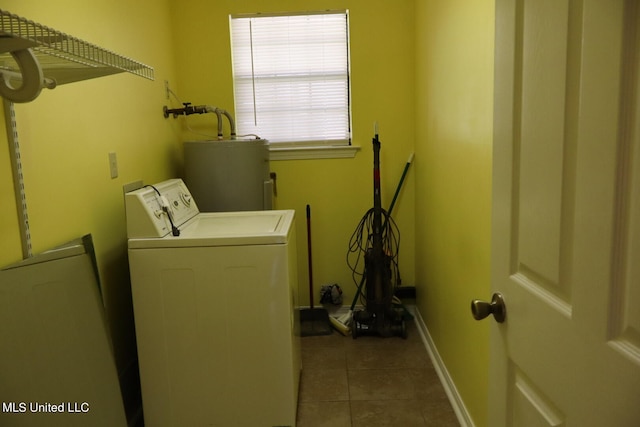 clothes washing area with water heater, washer and dryer, and light tile patterned floors