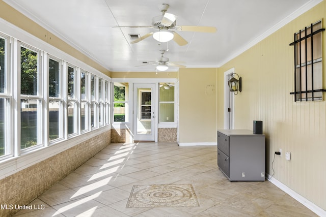 unfurnished sunroom with ceiling fan