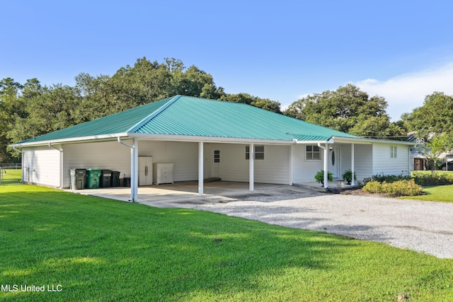 rear view of property featuring a yard and a carport