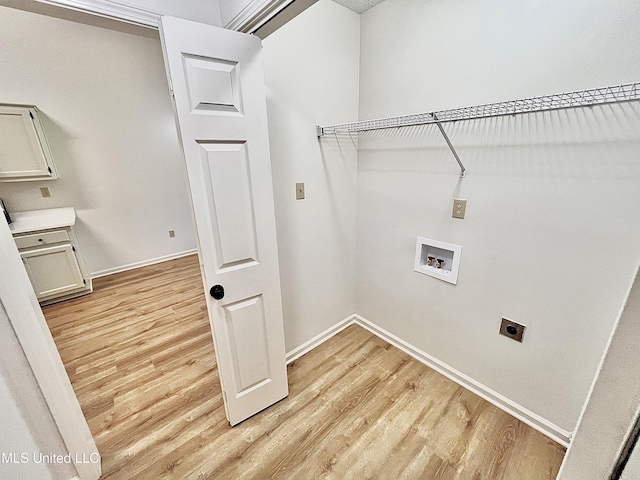 7164 Kimlee Cv, Southaven, MS 38671 - laundry room featuring hookup for an electric dryer, light wood-type flooring, baseboards, and hookup for a washing machine