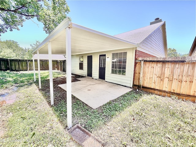 7164 Kimlee Cv, Southaven, MS 38671 - rear view of house with a patio, a chimney, and a fenced backyard